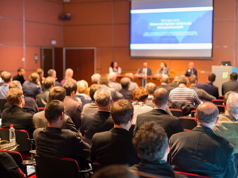 Audience attentively listening at a professional conference or seminar.