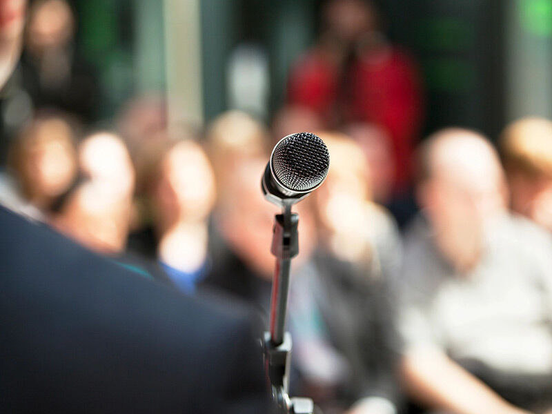 Microphone ready for a speaker in front of an audience.